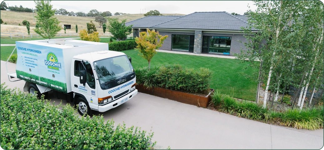 Coochie HydroGreen service truck parked at a freshly treated lawn